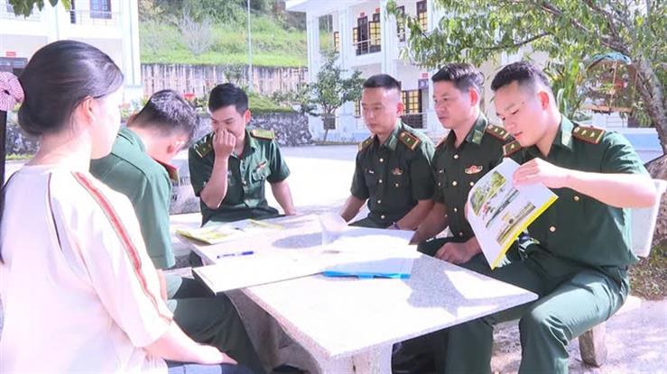 A group of men in uniform sitting at a tableDescription automatically generated