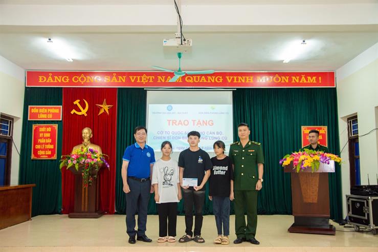 A group of people standing in front of a podiumDescription automatically generated