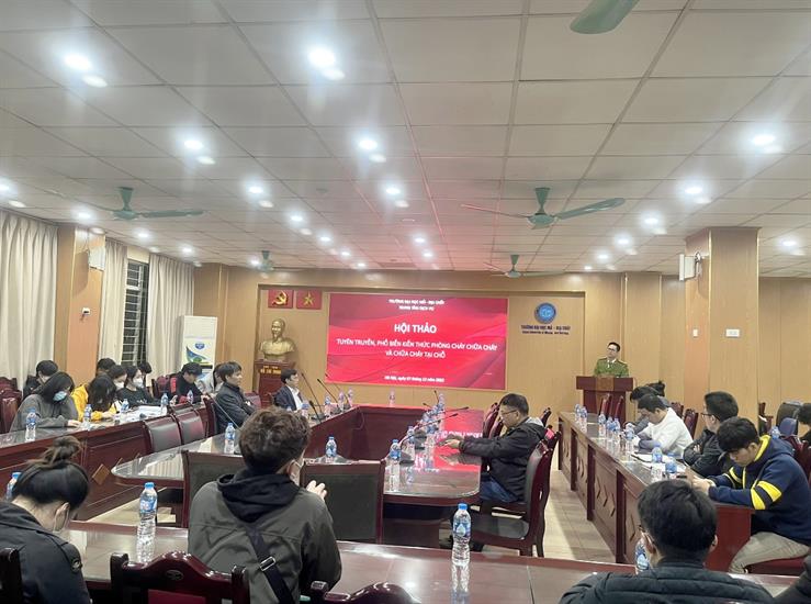 A group of people sitting in a room with a large screenDescription automatically generated with low confidence